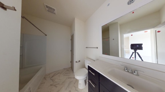 a bathroom with a sink toilet and a mirror
