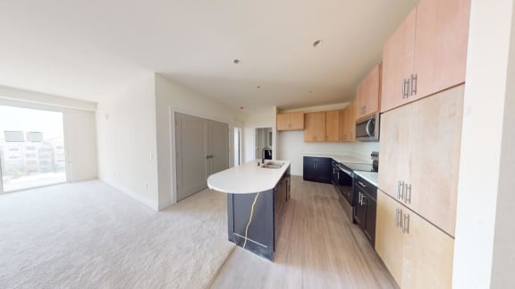 a kitchen with a white counter top in a large room