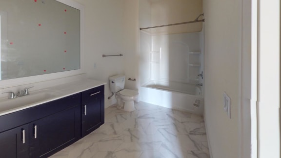 an empty bathroom with a toilet and a sink