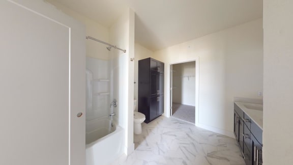 a bathroom with a shower and a sink and a toilet