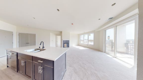 a kitchen and living room with a sink and a counter