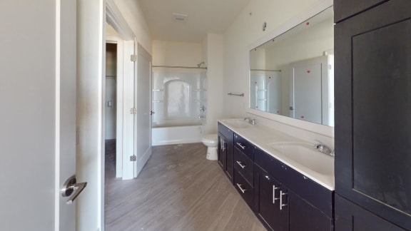 a bathroom with a large mirror and a long counter top