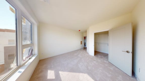 a living room with a large window and a door
