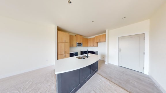 a kitchen with a white counter top and wooden cabinets