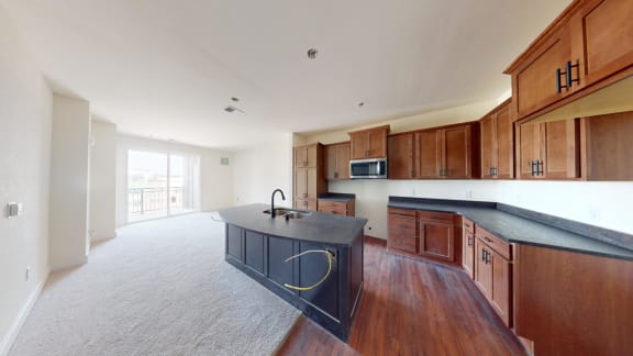a large kitchen with wooden cabinets and a black counter top