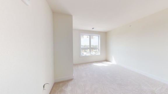 an empty living room with a window in it