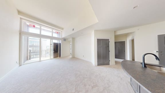 the living room and dining room of an empty apartment