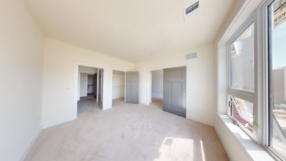 an empty living room with a large window