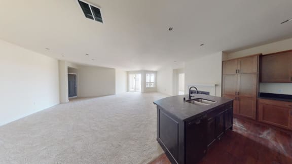 an empty living room with an island in the middle
