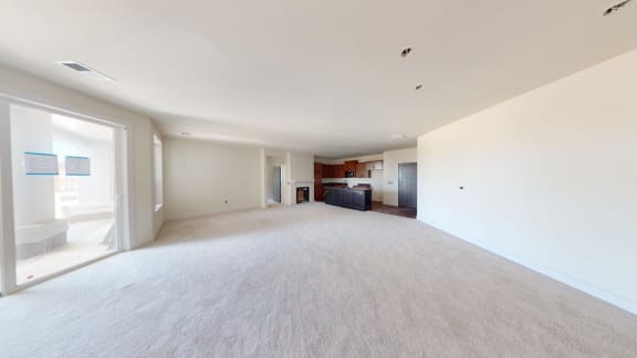 an empty living room and kitchen in a house