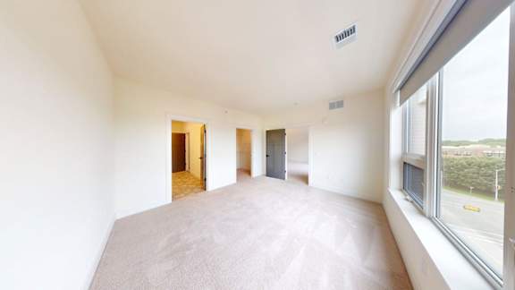 Empty room with white walls and carpet.