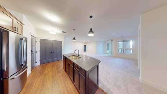 A kitchen with wooden floors and a large island.