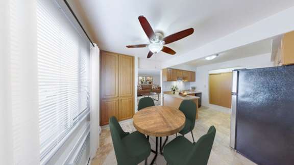 A kitchen with a table and chairs in the middle of the room.