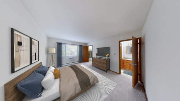 A bedroom with a bed, a dresser, a mirror, and a window.