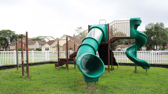 a playground with a slide and monkey bars at Highview Manor Apartments, Fairport, NY, 14450