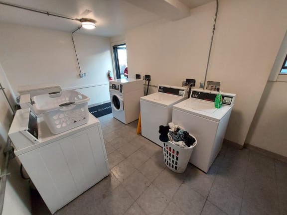 a laundry room with four washes and a washing machine