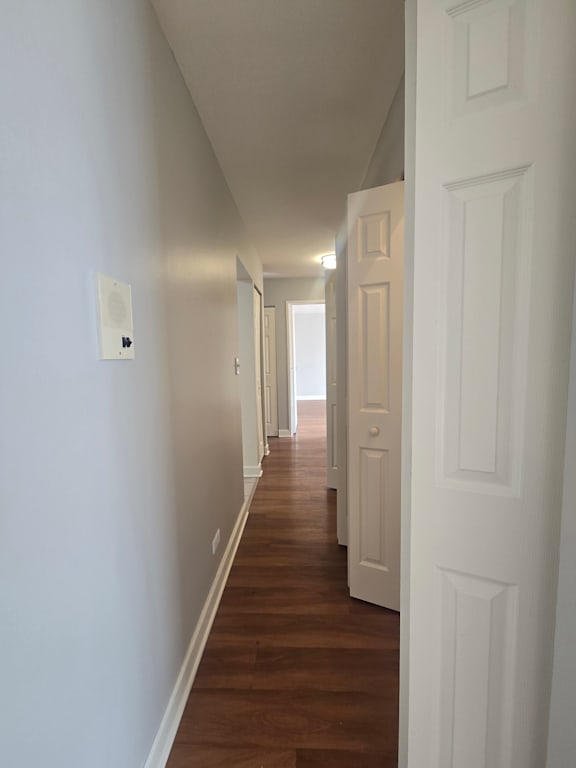 A room with wooden walls and a white ceiling with a skylight.