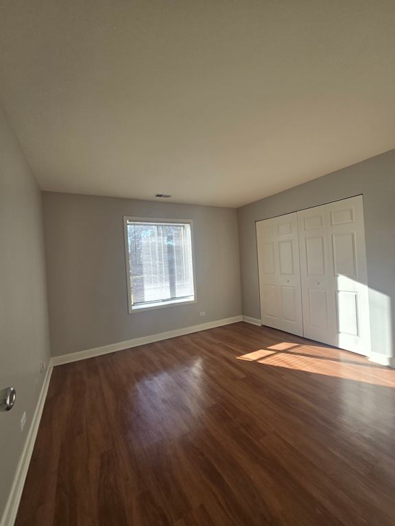 A small window in a room with wooden walls.