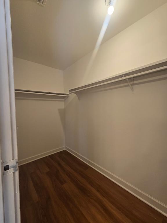A white ceiling with a light fixture and a white beam.