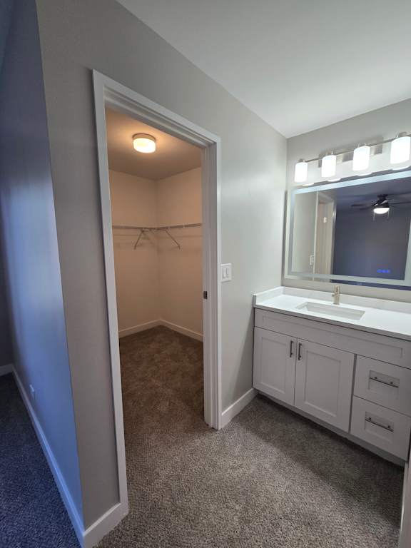 A mirrored cabinet with lights above it.