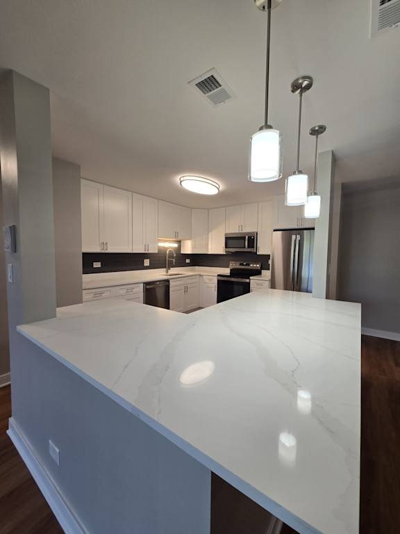 A modern kitchen with a large island in the center.