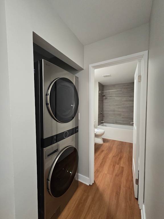 A modern kitchen with a stove top oven and two pans on the stove.