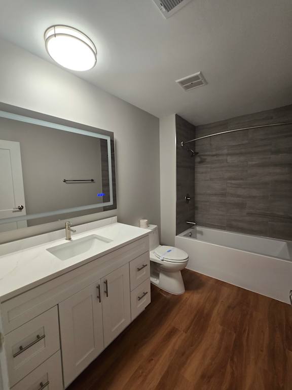 A modern bathroom with a wooden ceiling and white walls.