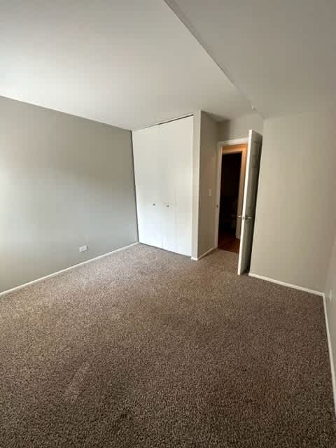 an empty room with a carpeted floor