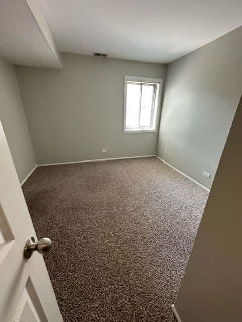 an empty room with a window and a door