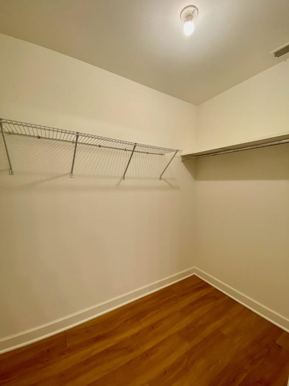 Empty room with a shelf and a clothes rack.