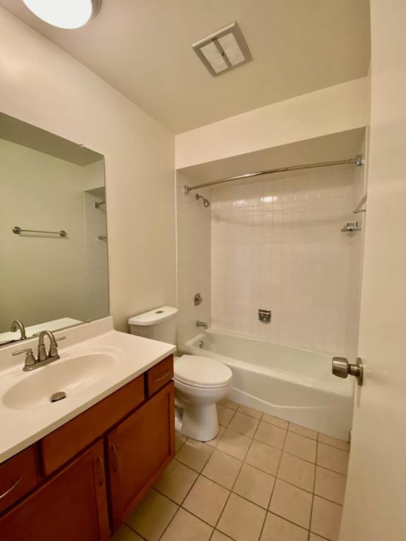 A bathroom with a toilet, sink, and shower.