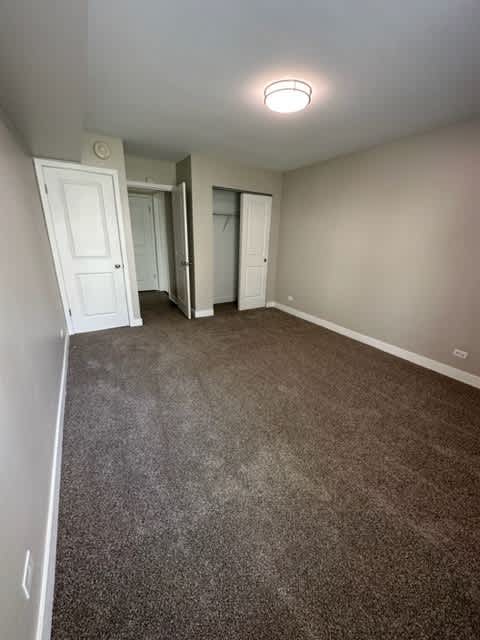 an empty room with a carpeted floor