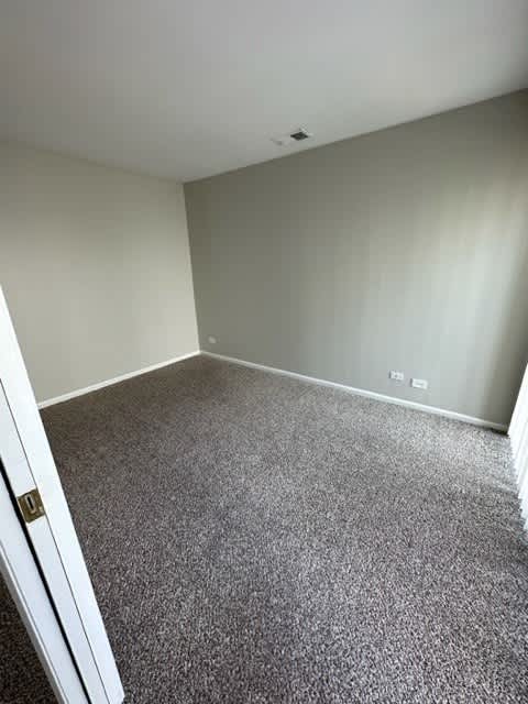 an empty room with a carpeted floor