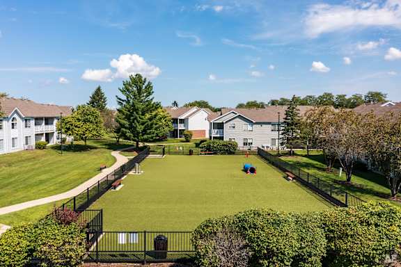 A residential area with houses and a green lawn.