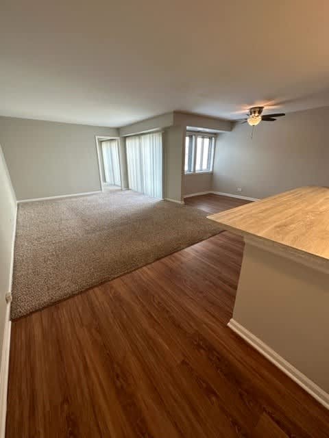a bedroom with a bed and a ceiling fan