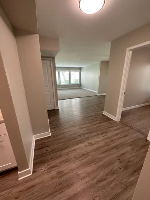 an empty living room with a hardwood floor