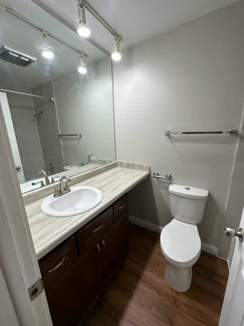 a bathroom with a sink toilet and mirror