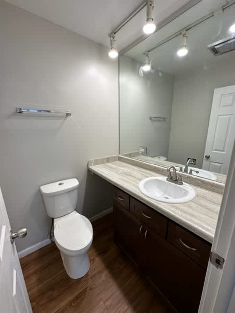 a bathroom with a toilet sink and mirror