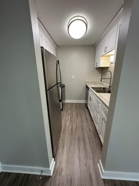 a kitchen with a refrigerator and a sink