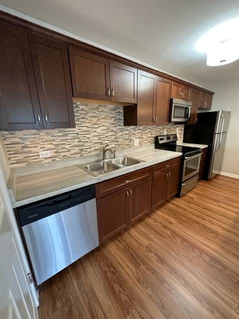 a kitchen with a stove a sink and a refrigerator