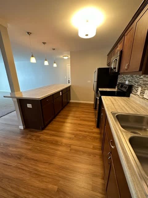 a kitchen with a wooden floor and a sink