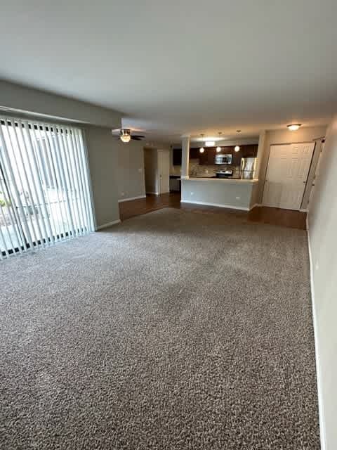 an empty living room with a large window