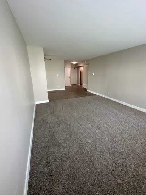 an empty room with a carpeted floor