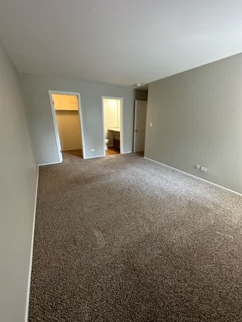 an empty room with a carpeted floor