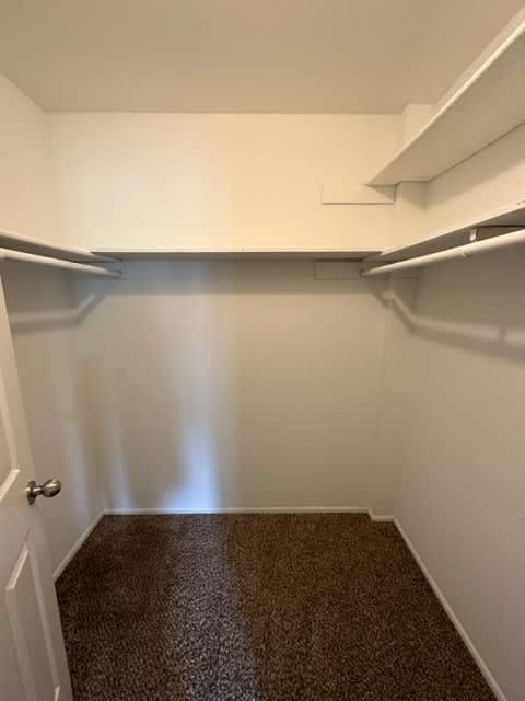 a small room with a door and a shelf on the wall