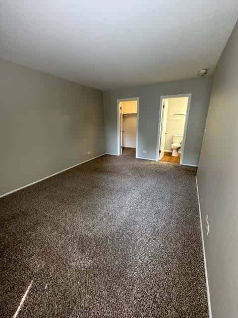 an empty room with a carpeted floor