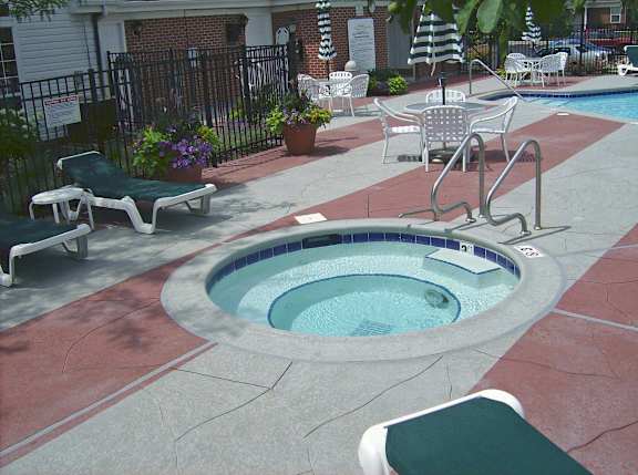 A small pool with a metal fence around it.