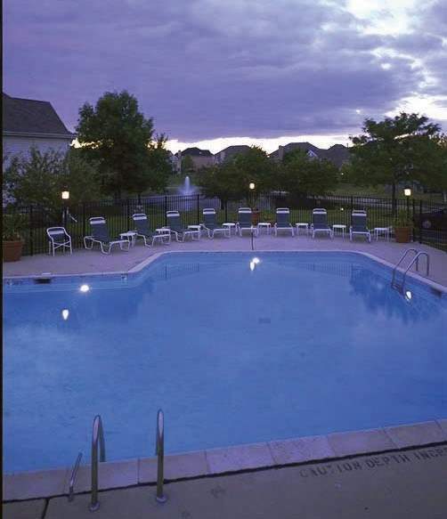 A pool with chairs around it and a sign that says