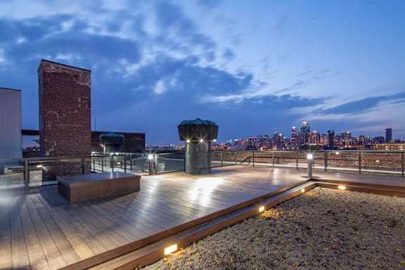 A rooftop with a wooden floor and a brick chimney.