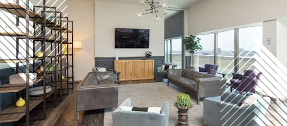 A living room with a grey couch and a wooden cabinet.